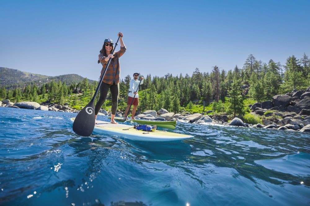 Couple paddleboarding on Lake Tahoe. 