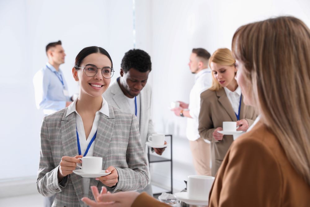 young businesspeople talking while drinking coffee