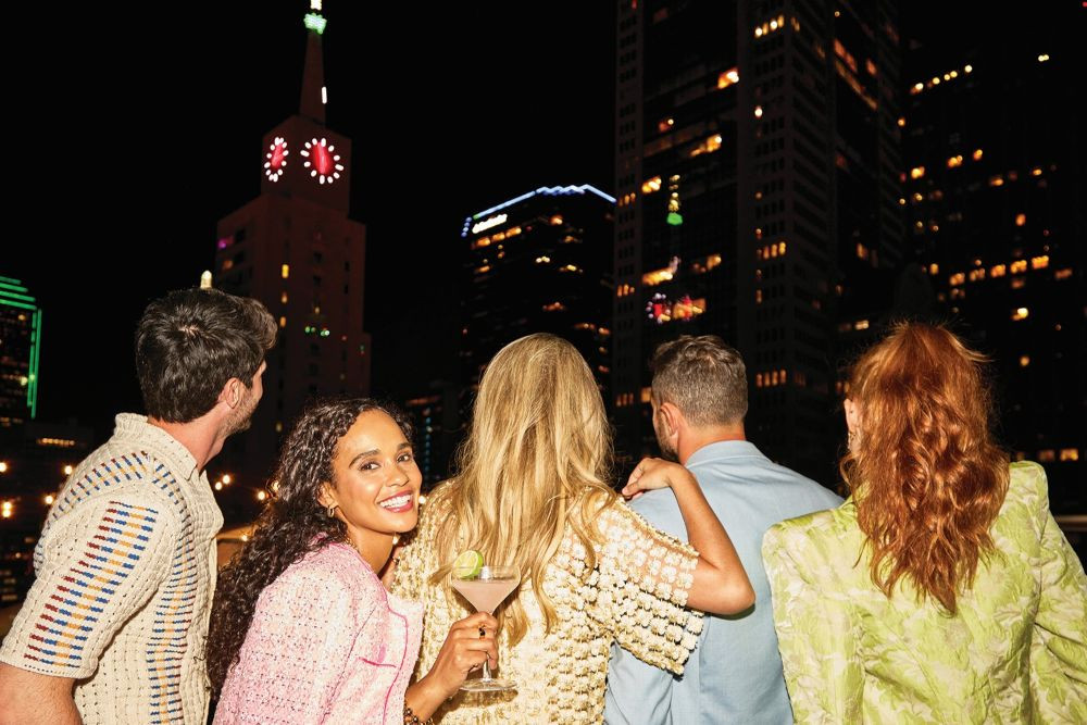 Five people enjoy Dallas night life. 