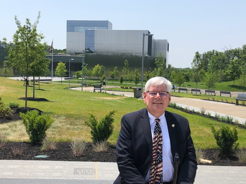 Dean Miller standing in the foreground of the National Museum of the United States Army.