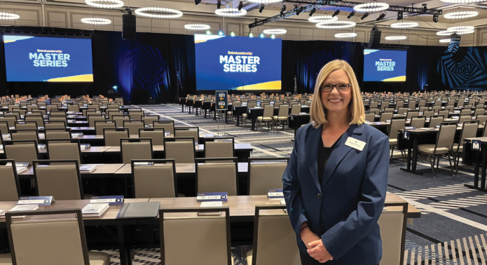 planner standing in back of ballroom
