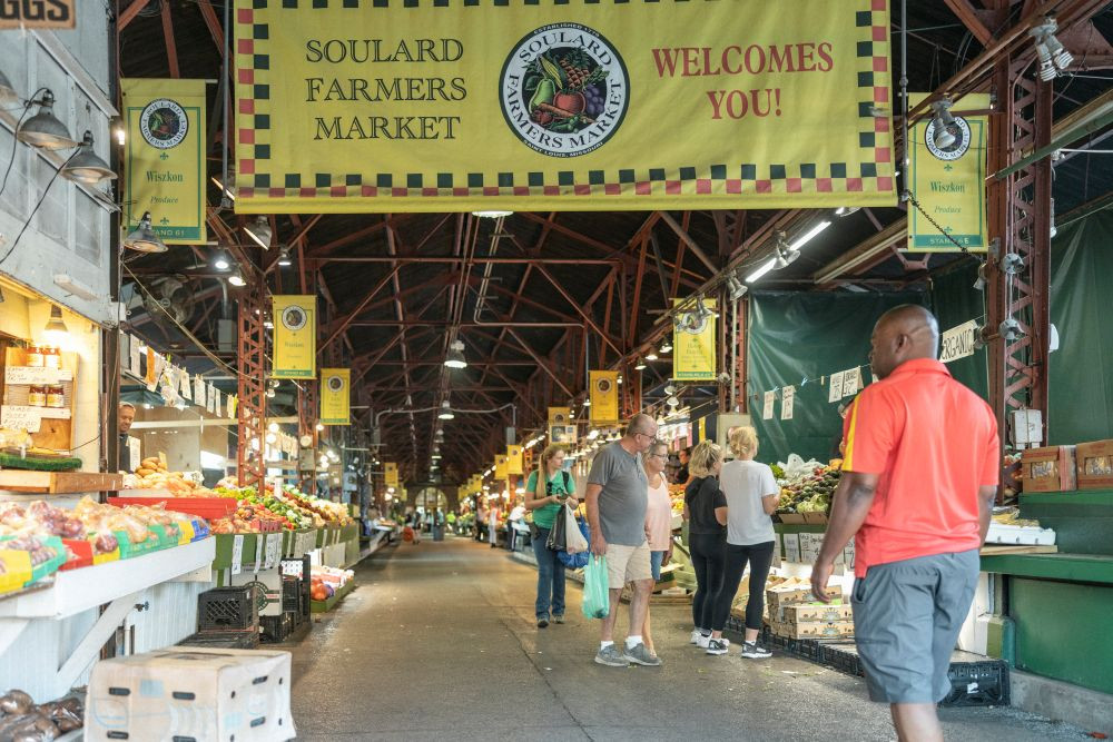 Photo of a man walking through the Soulard District in St. Louis.