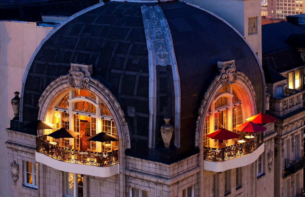 Rooftop balcony of The Bellevue Hotel at night.