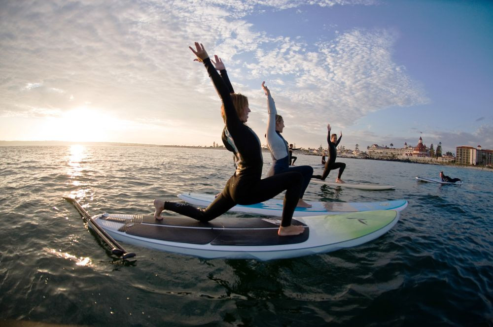 People doing stand-up yoga on paddleboards.
