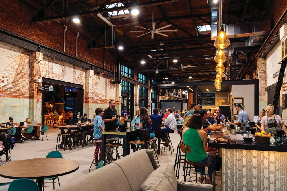 Armature Works food hall, with people sitting at a counter.