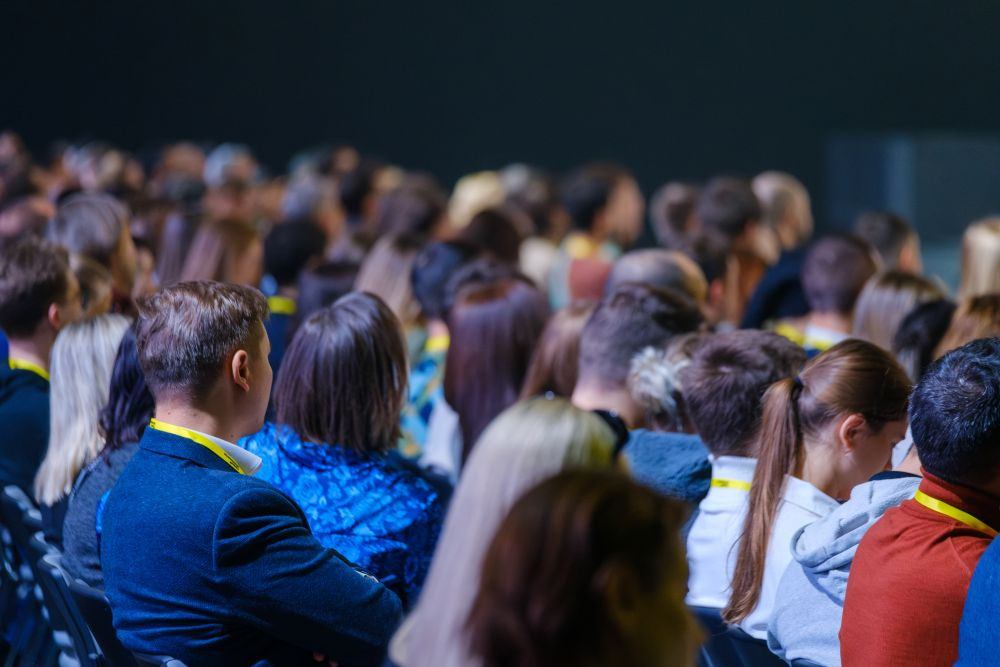 Image of a crowd of people at a meeting.