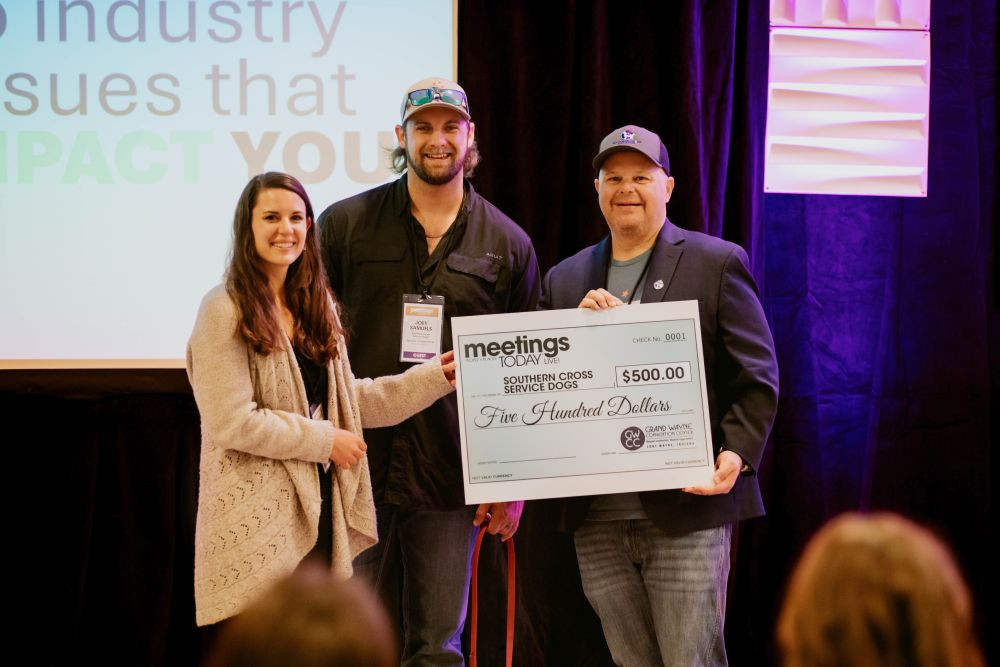 Grand Wayne Convention Center presents Southern Cross Service Dogs with $500 check. 