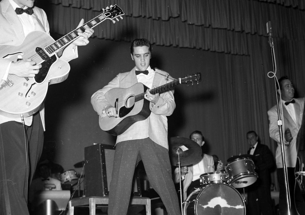 Elvis Presley performing on stage in the 1950s.