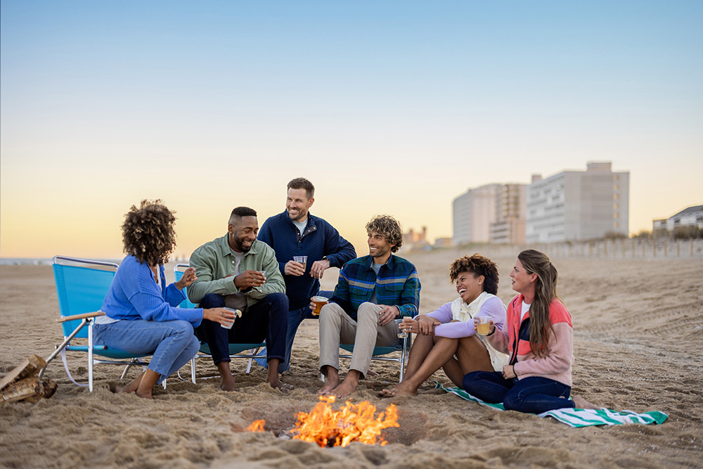 Group meeting around a campfire on the beach in Ocean City, Maryland