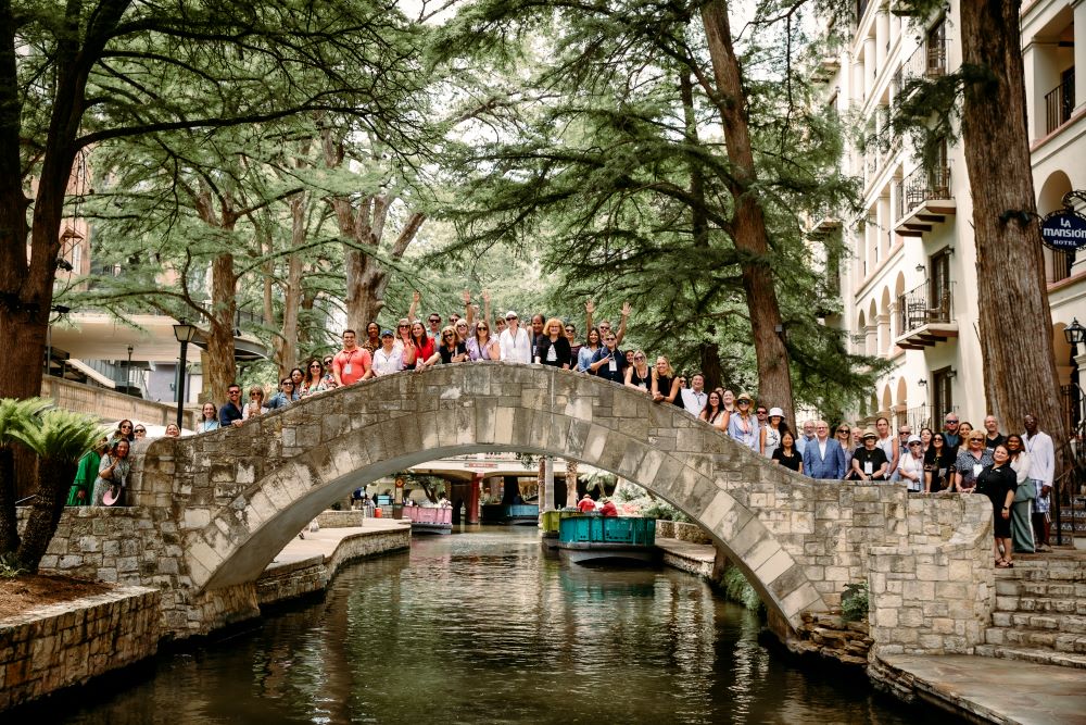 Meetings Today Live group poses on the San Antonio River Walk
