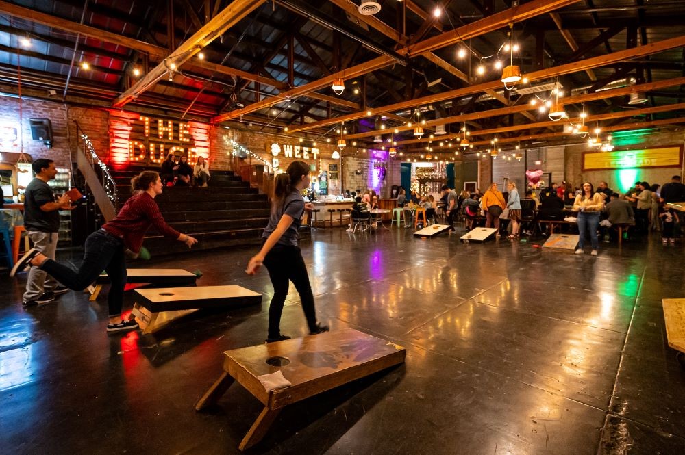 Photo of people playing cornhole at The Duce lounge in Phoenix.