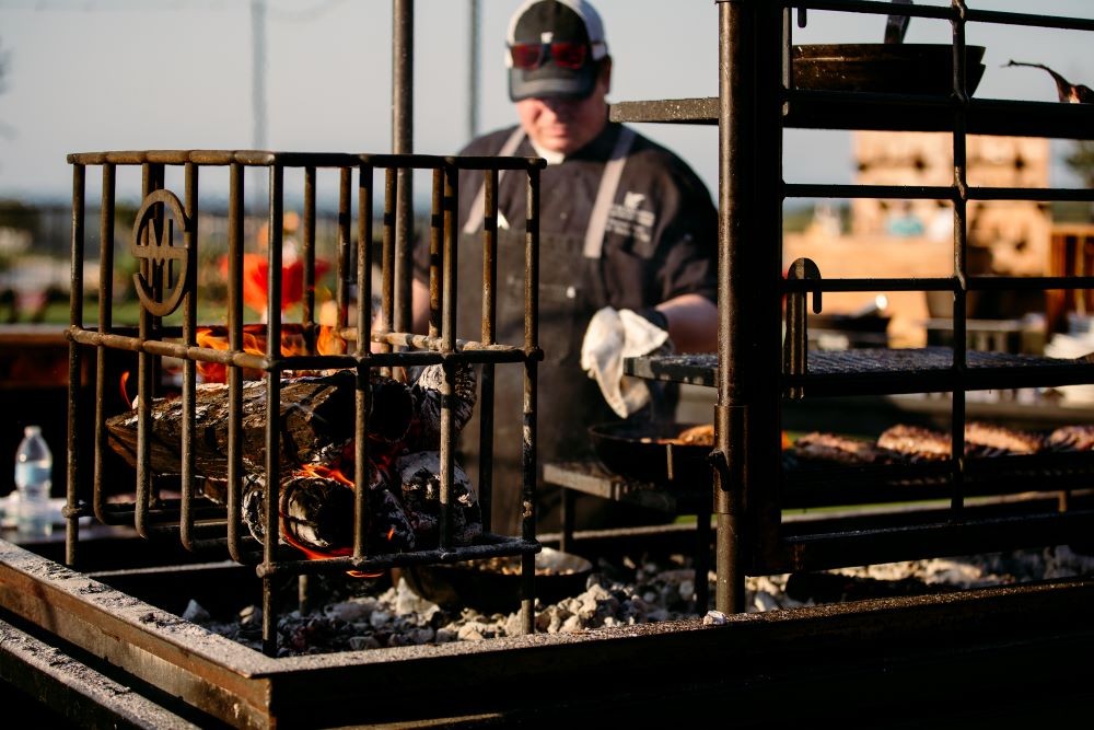 Wood-fired barbecue grill cooks food at MT LIVE! National in San Antonio
